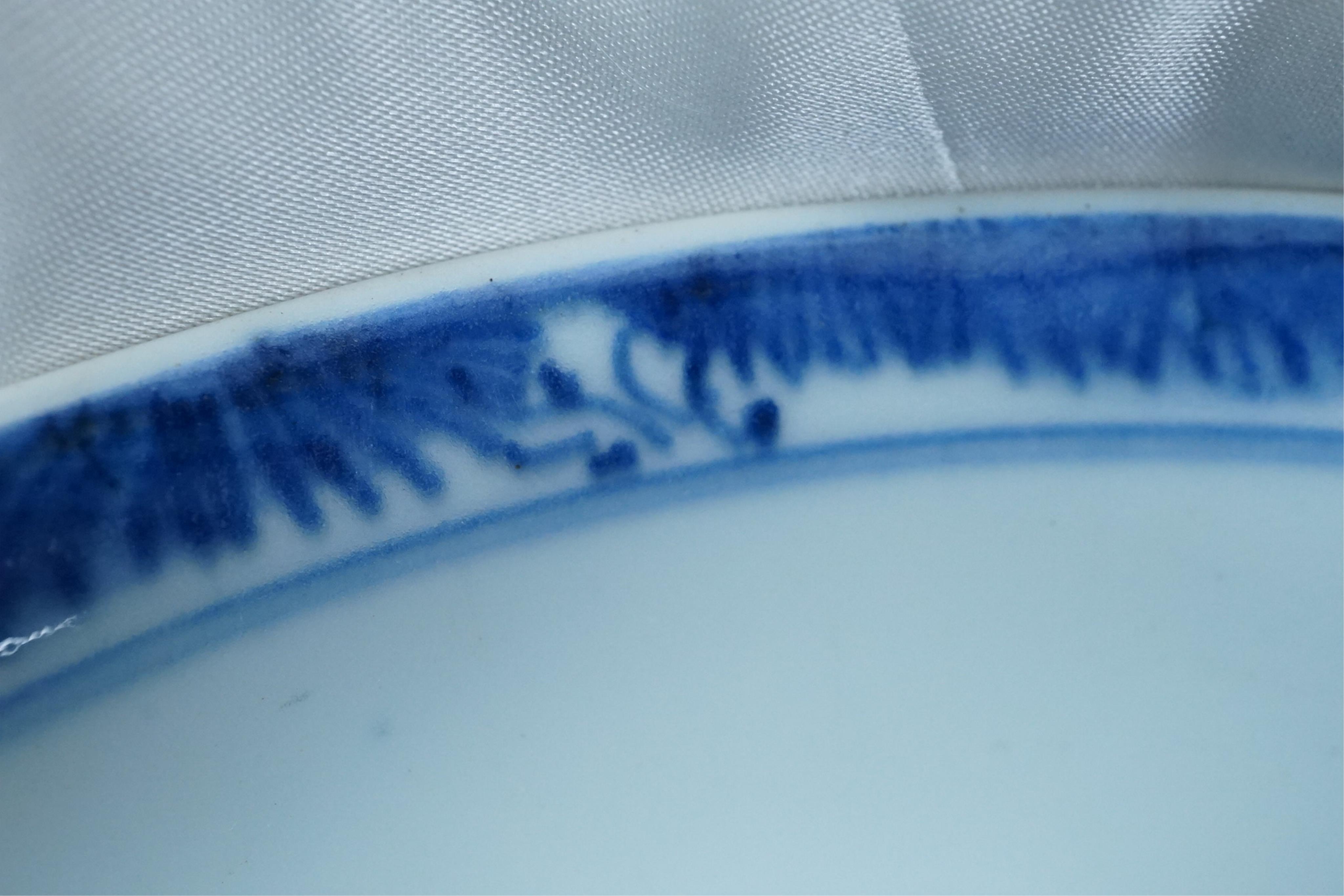 A pair of Chinese Transitional blue and white 'mythical beasts' bowls, early Kangxi period